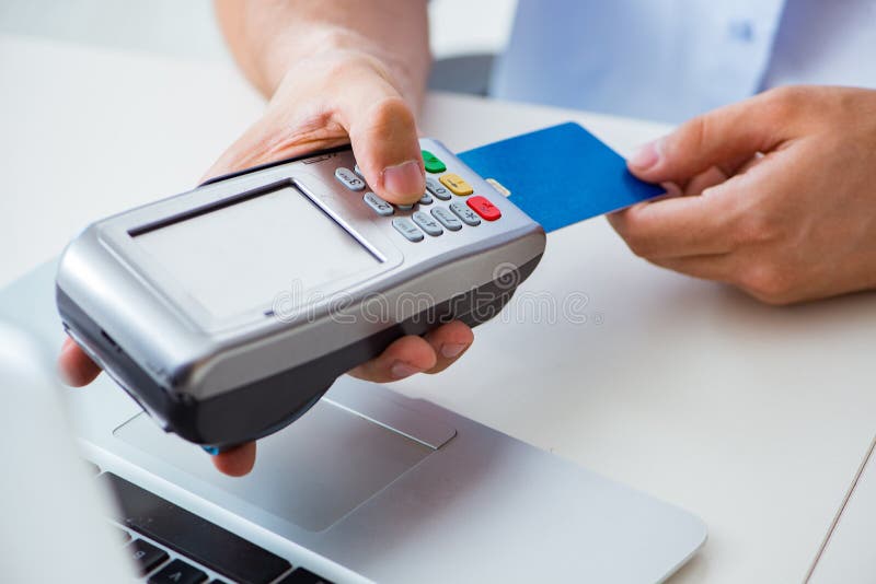 The man processing credit card transaction with pos terminal royalty free stock images The man processing credit card transaction with pos terminal royalty free stock images