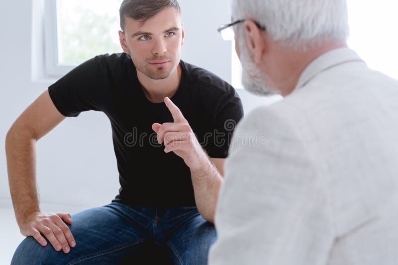 Man and professional counselor during psychotherapy for people with ptsd stock image
