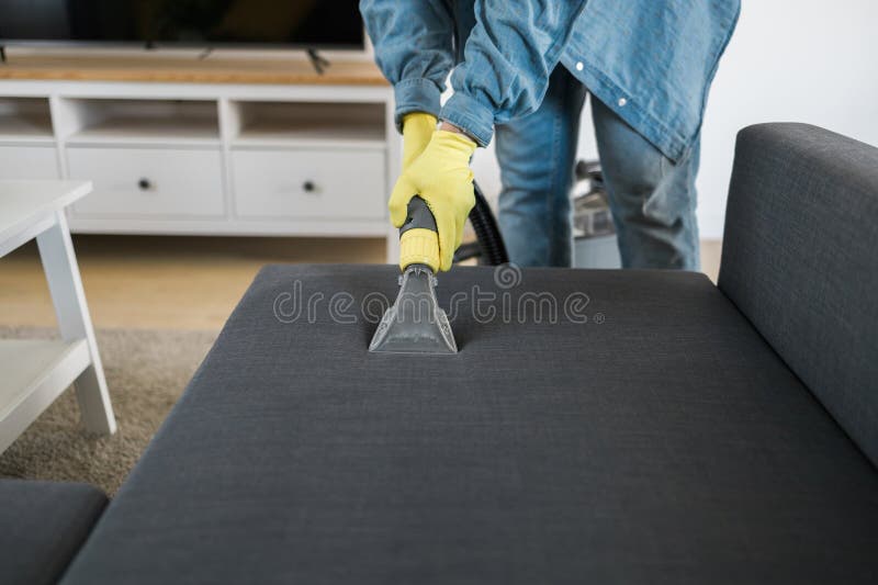 Man in Protective Rubber Glove Cleaning Sofa with Professionally