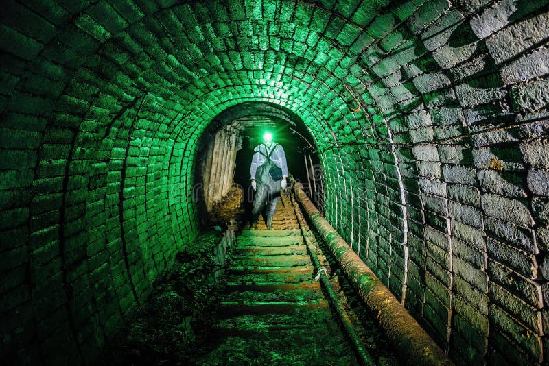 Man in protective suit inside abandoned uranium mine royalty free stock images
