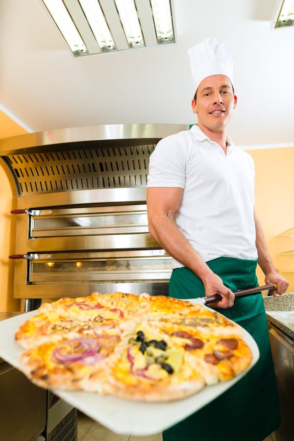Man Pushing the Finished Pizza from the Oven Stock Image - Image of ...