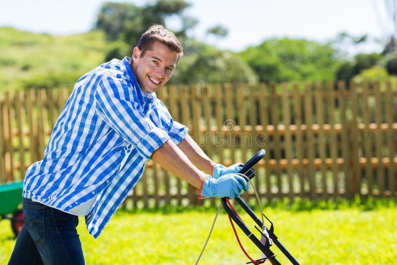 Couple Outdoors with Tools and Lawnmower Smiling Stock Image Image of