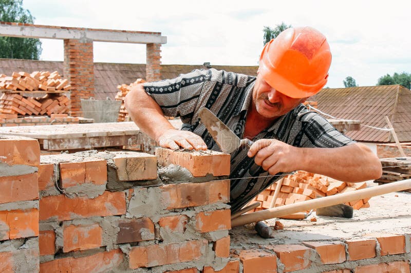 Man puts a brick editorial photography. Image of building 125324192