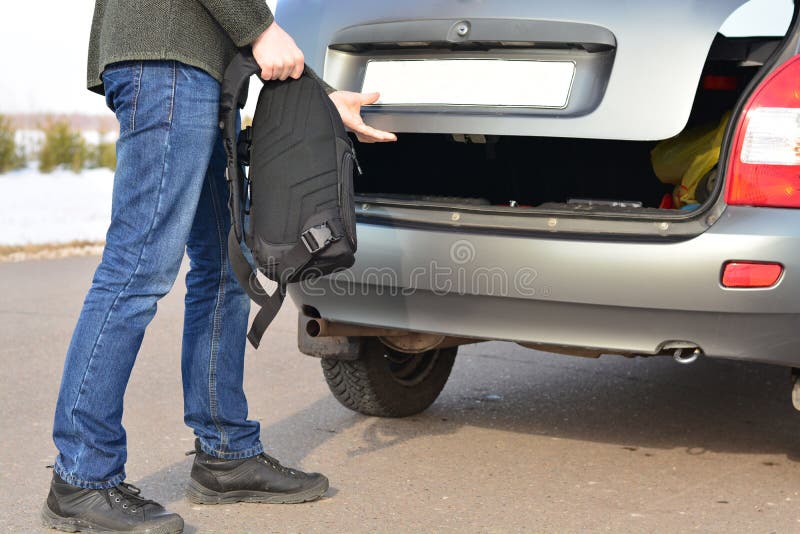 The Man Puts His Backpack in the Car Stock Photo Image of meadow
