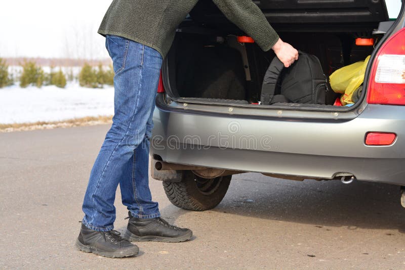 The Man Puts His Backpack in the Car Stock Photo Image of meadow