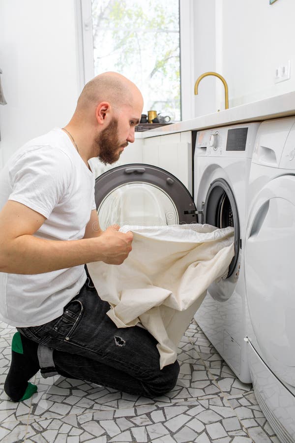 Man Puts Laundry in a Washing Machine Stock Image Image of dirty