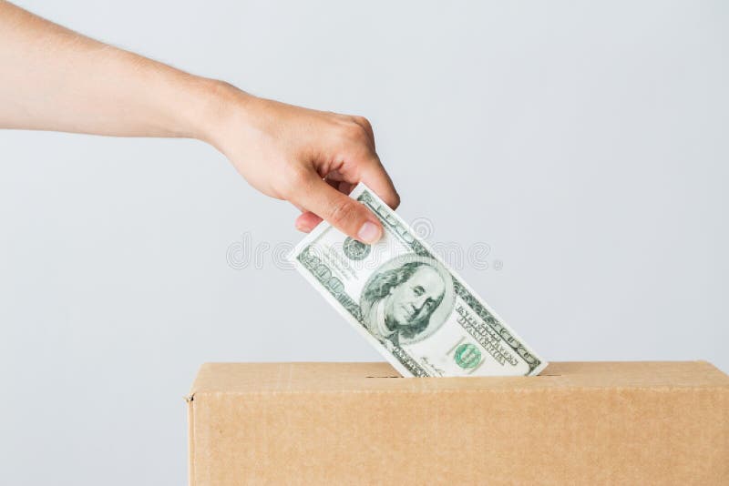 Man putting dollar money into donation box