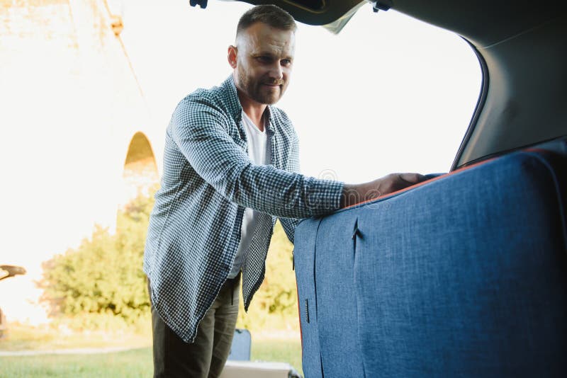 Man Putting Luggage into Car Trunk Stock Photo Image of lifestyle
