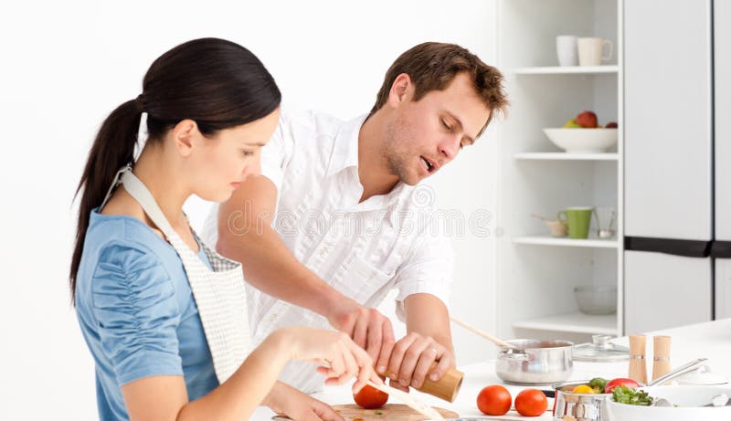 Man putting salt and pepper with his wife royalty free stock photos Man putting salt and pepper with his wife royalty free stock photos
