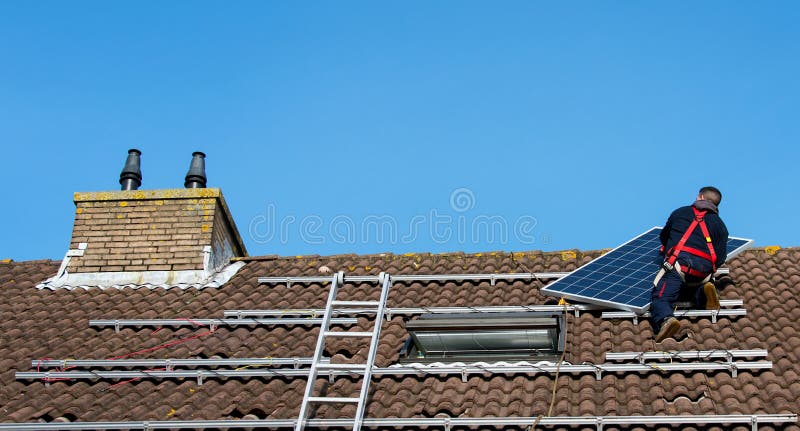 Man putting the solar panel on the roof