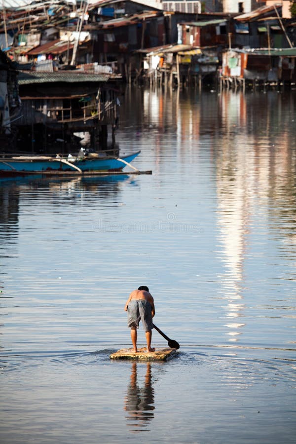 Man on raft - squatter shanty area stock photos Man on raft - squatter shanty area stock photos