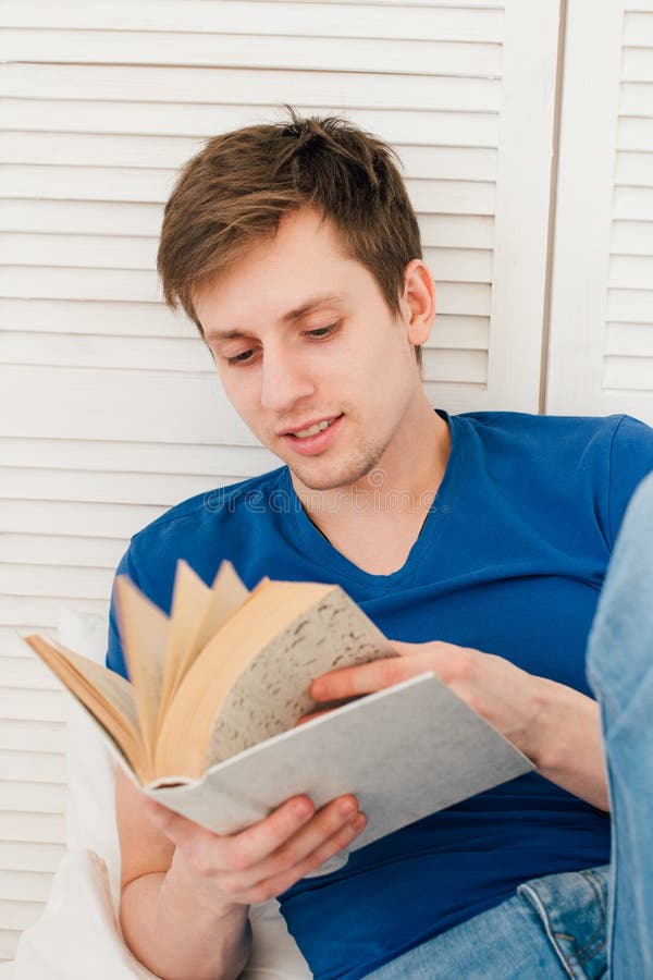 Man Reading a Book Sitting on the Bed Stock Photo Image of smart