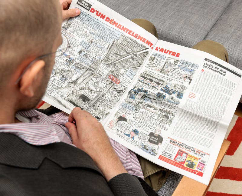 Man reading Charlie Hebdo having fun about satire cartoon stock image Man reading Charlie Hebdo having fun about satire cartoon stock image