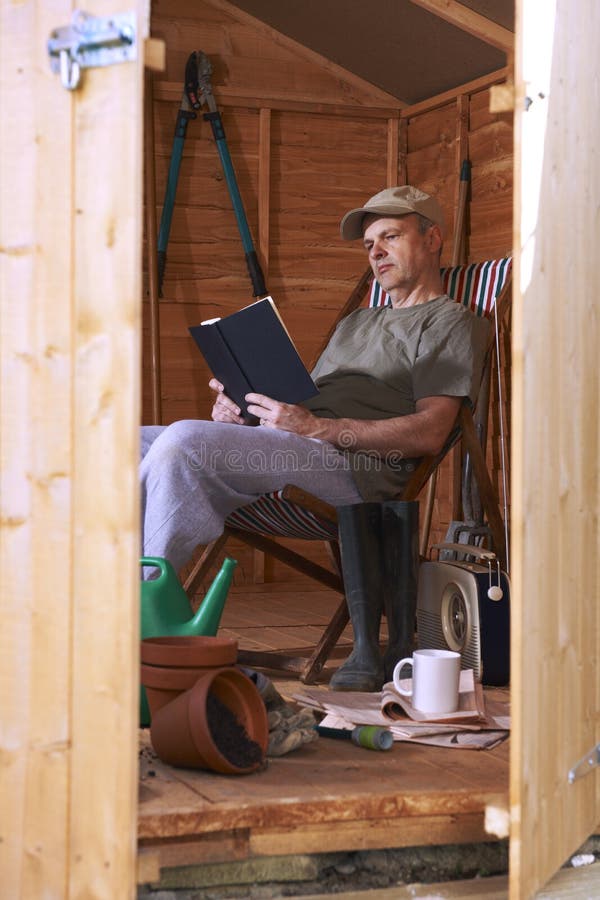 Man reading in garden shed stock photos Man reading in garden shed stock photos