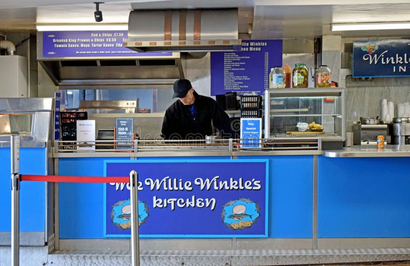 A man behind the counter of a fish and chip shop. royalty free stock photography A man behind the counter of a fish and chip shop. royalty free stock photography