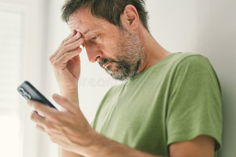 Man received worrying text message or e-mail on smartphone stock images
