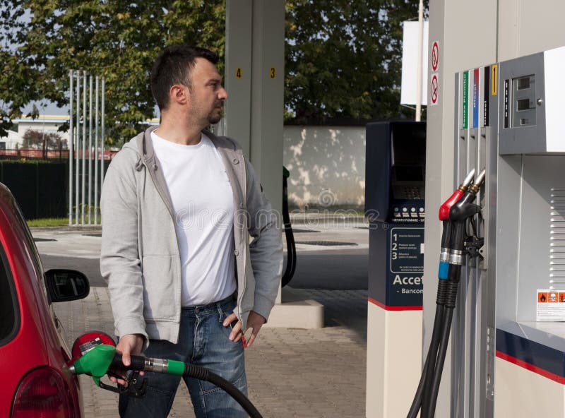 Gas Jockey Refilling Car stock photo. Image of jockey 16686322