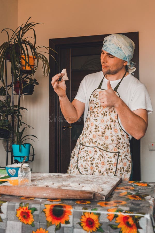 The man rejoices. for the first time properly cooked raw dumpling royalty free stock photography