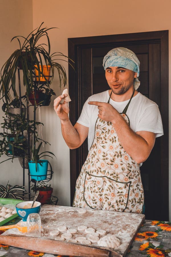 The man rejoices. for the first time properly cooked raw dumpling stock photo