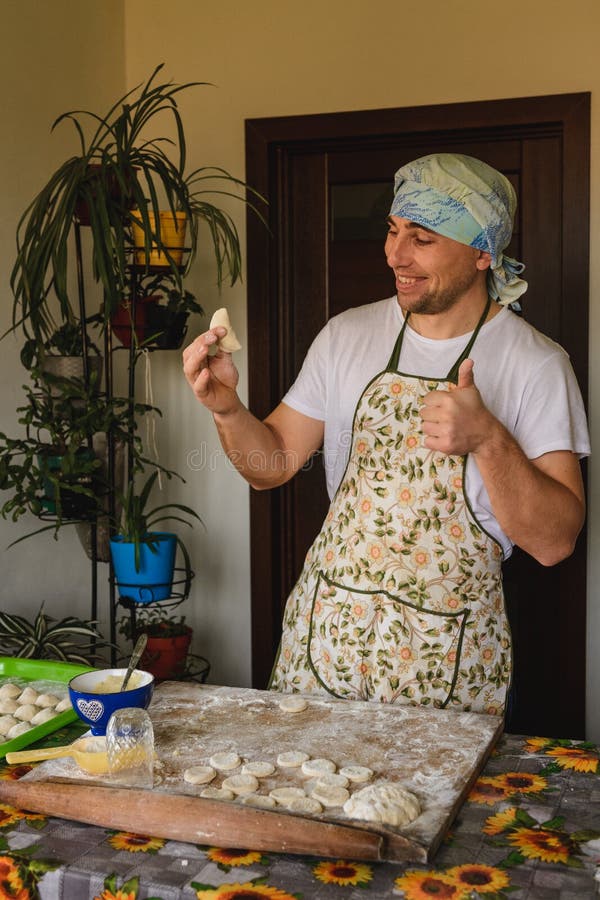 The man rejoices. for the first time properly cooked raw dumpling stock photo