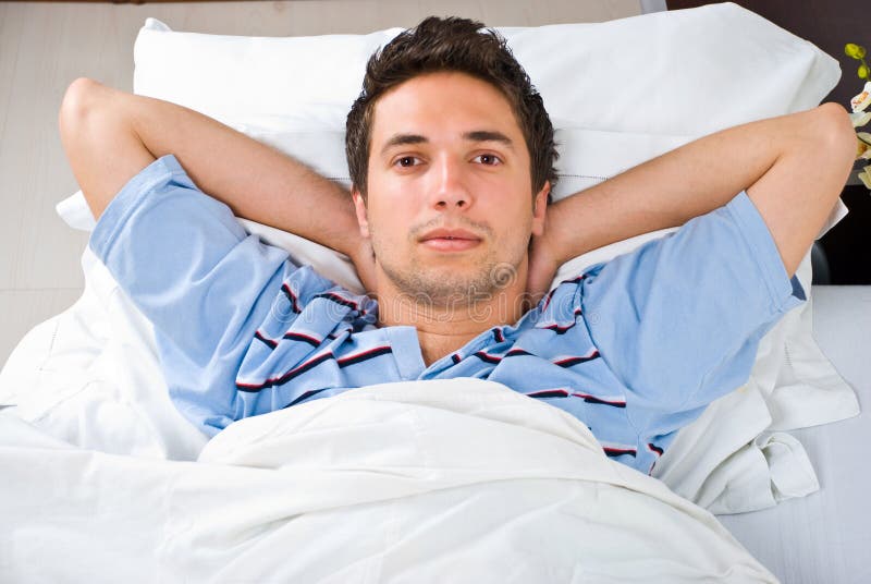 Man relaxing in bed stock photos Man relaxing in bed stock photos