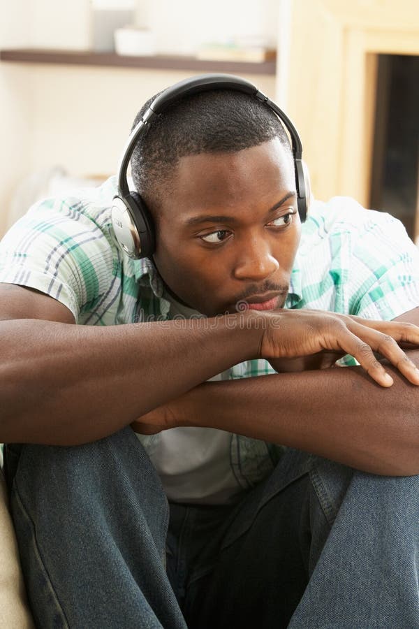 Man Relaxing Sitting On Sofa Listening to Music