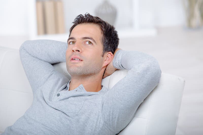 Man Relaxing on Sofa at Home Stock Photo Image of person, confident