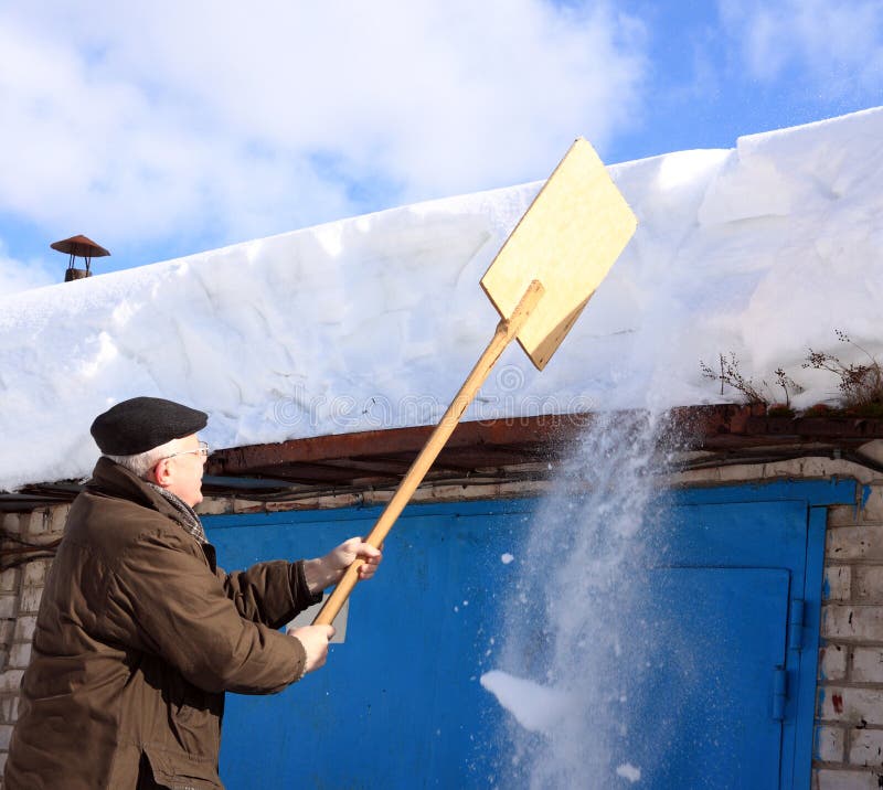 Man Removing Snow from a Roof with a Shovel Stock Image Image of