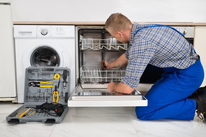 Man Repairing Dishwasher royalty free stock photography