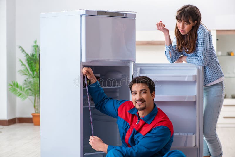 The Man Repairing Fridge with Customer Stock Image Image of