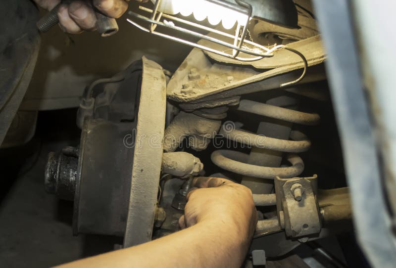 A Man Repairs a Car. Repair of the Machine. the Hand of the Machine is