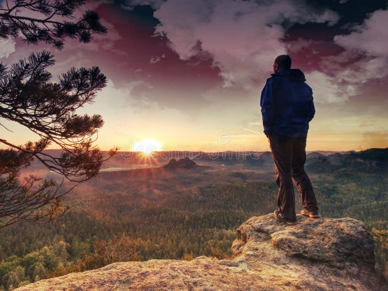 Man rest on mountain peak in background hills and clouds stock photography Man rest on mountain peak in background hills and clouds stock photography