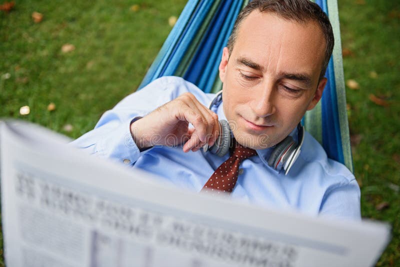 Man resting after work with paper royalty free stock photo Man resting after work with paper royalty free stock photo