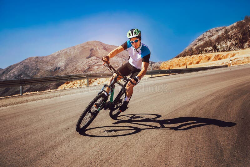 Man ride mountain bike on the road.