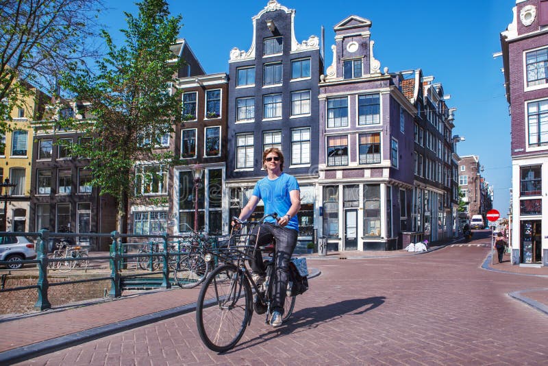 Riding a bike in Amsterdam stock image. Image of rusty 33153395