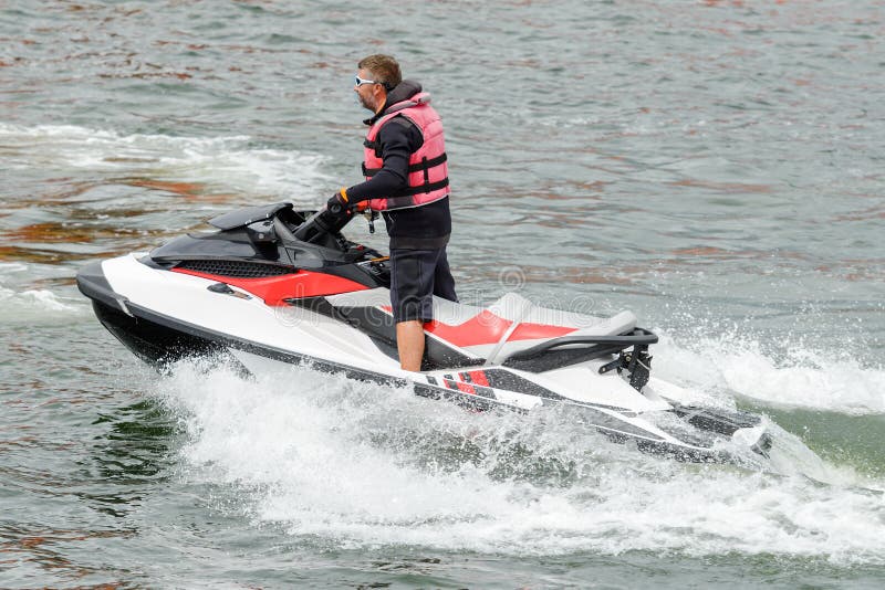 Man riding a jet ski stock image. Image of excitement 123978407