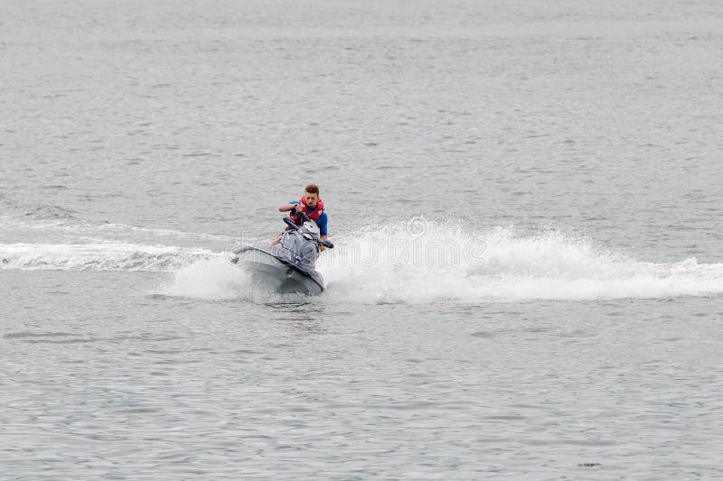 Man riding a jet ski stock image. Image of nautical 123978419