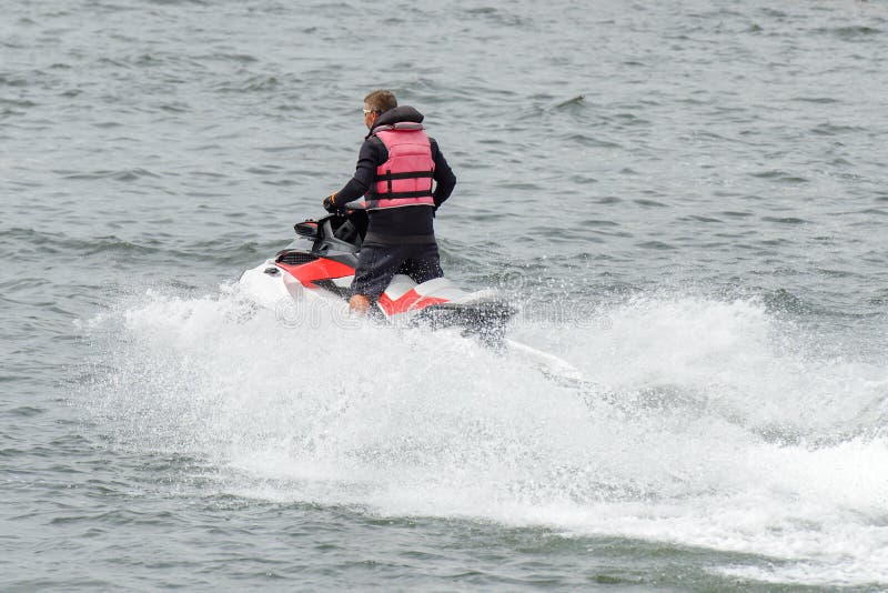 Man riding a jet ski stock photo. Image of riding, recreation 123978390