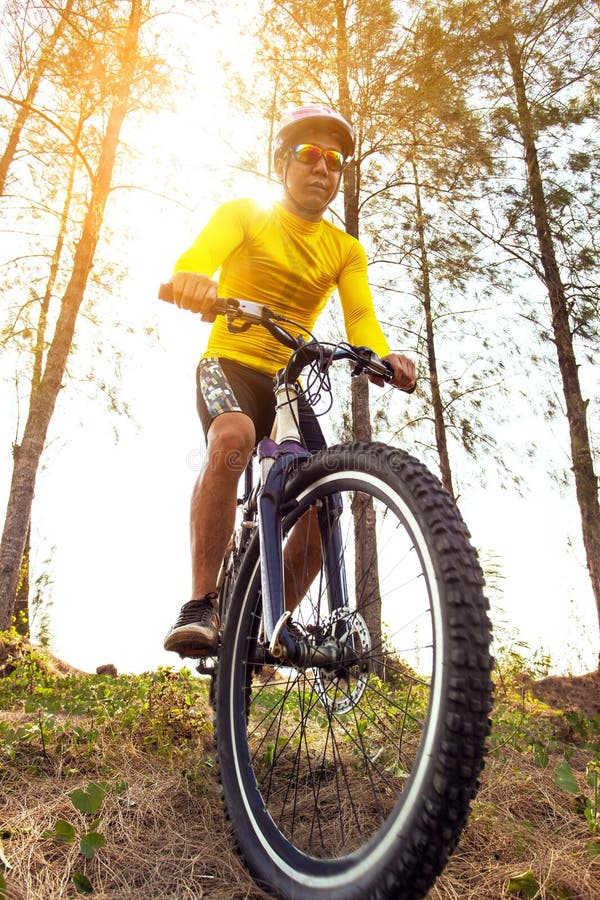 Man riding sport mountain bike on extreme track stock photo Man riding sport mountain bike on extreme track stock photo