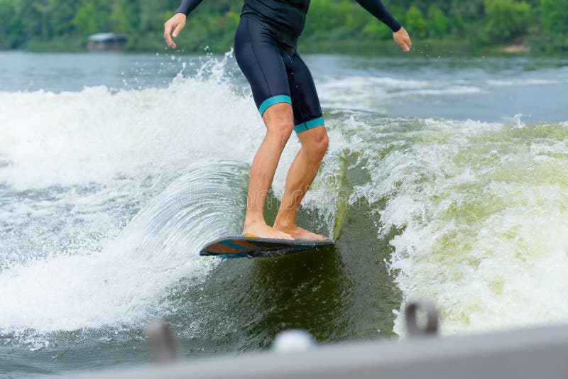 Man Riding a Wakeboard Behind a Boat Stock Image Image of nature