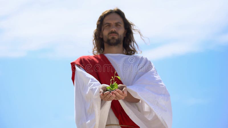 Man in robe showing sprout against sky, nature saving, environmental problems. Stock photo stock photo Man in robe showing sprout against sky, nature saving, environmental problems. Stock photo stock photo