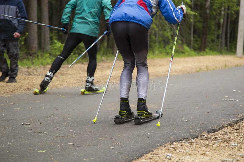 A Man on a Roller Ski Rides in the Park.Cross Country Skilling Stock