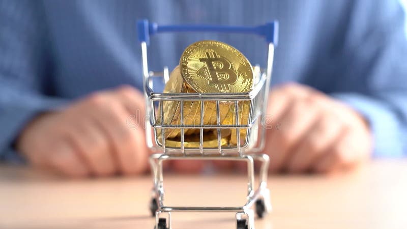 Man Rolling a Cart with Bitcoins. Bitcoin Price Rise Concept stock video footage