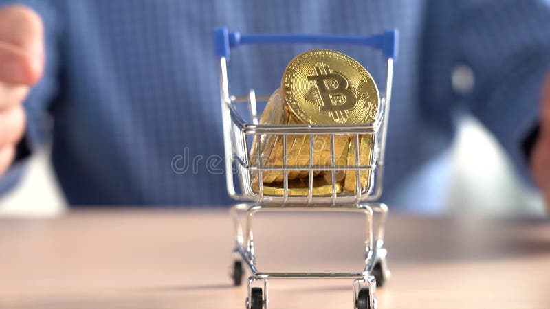Man Rolling a Cart with Bitcoins. Bitcoin Price Rise Concept stock video