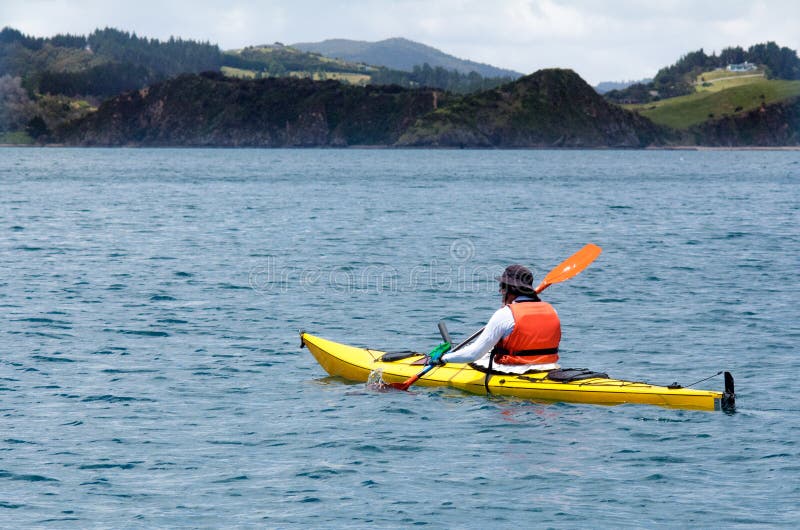 Man rows a sea kayak