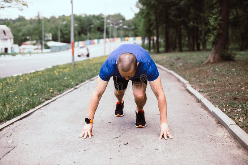 Man runner prepared for running in urban park stock images Man runner prepared for running in urban park stock images