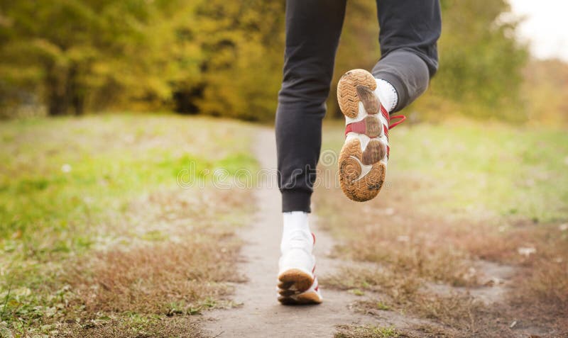 Running along a park path, healthcare and problem concept - close-up of an unhappy person suffering from pain in the leg or knee stock images