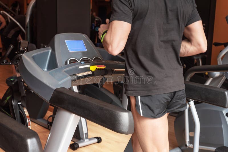 Man running in a modern gym on a treadmill, concept for exercising, fitness and healthy lifestyle. stock photos Man running in a modern gym on a treadmill, concept for exercising, fitness and healthy lifestyle. stock photos