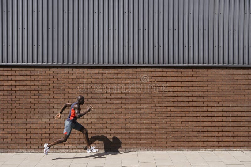 Man Running Past Brick Wall Stock Photos Free & RoyaltyFree Stock