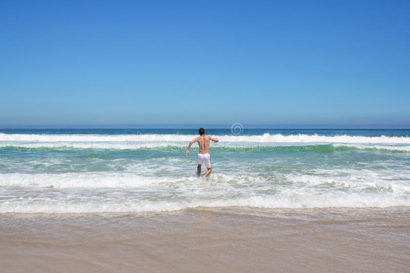 Man running in to water stock photos